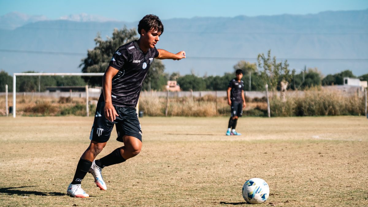 Young football player looking ahead while preparing the next action